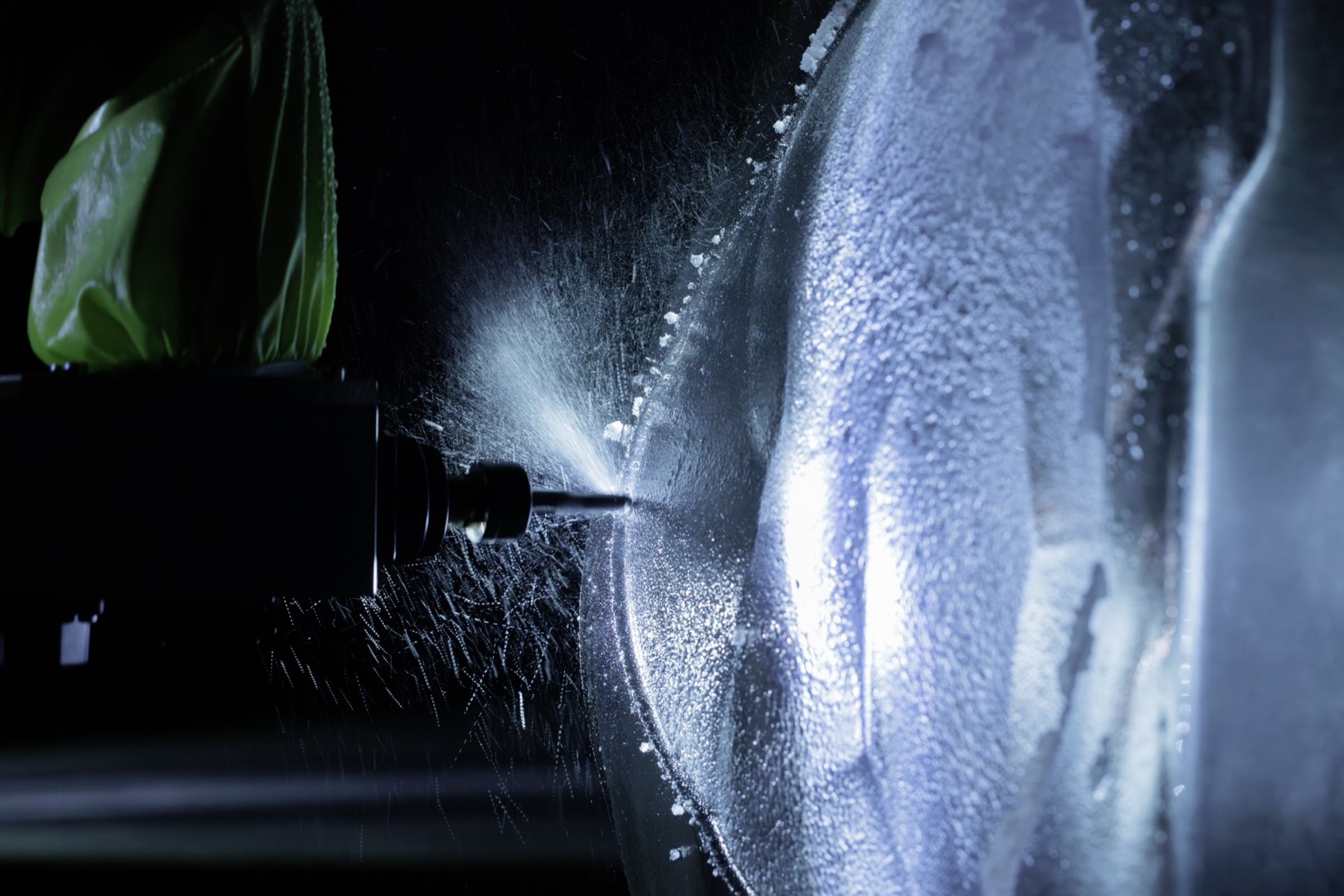 Closeup of drill bit carving into the ice block