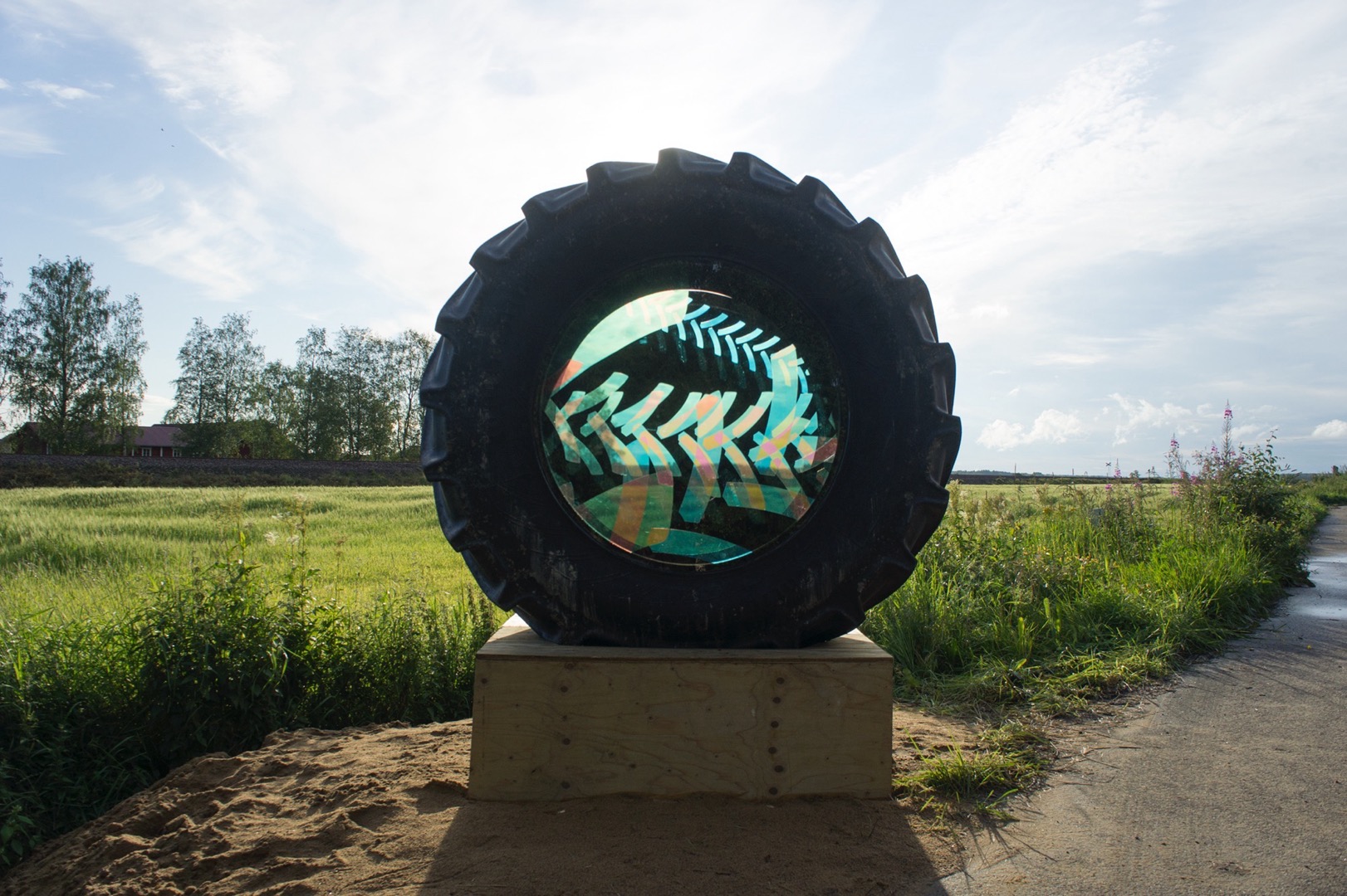Artwork installed on a tractor tire in the rural landscape