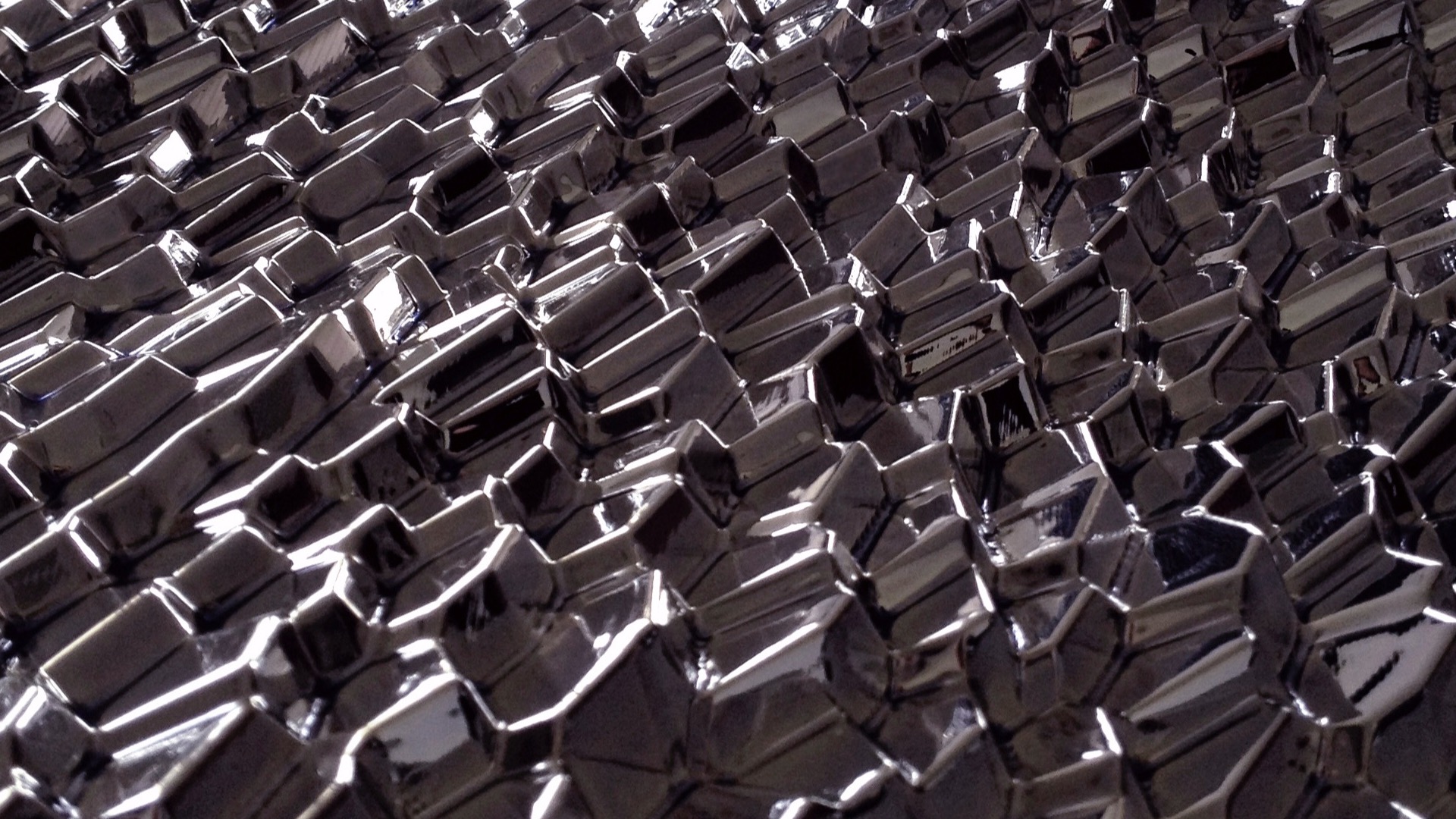 Computational caustics creating light patterns from chrome sculpture