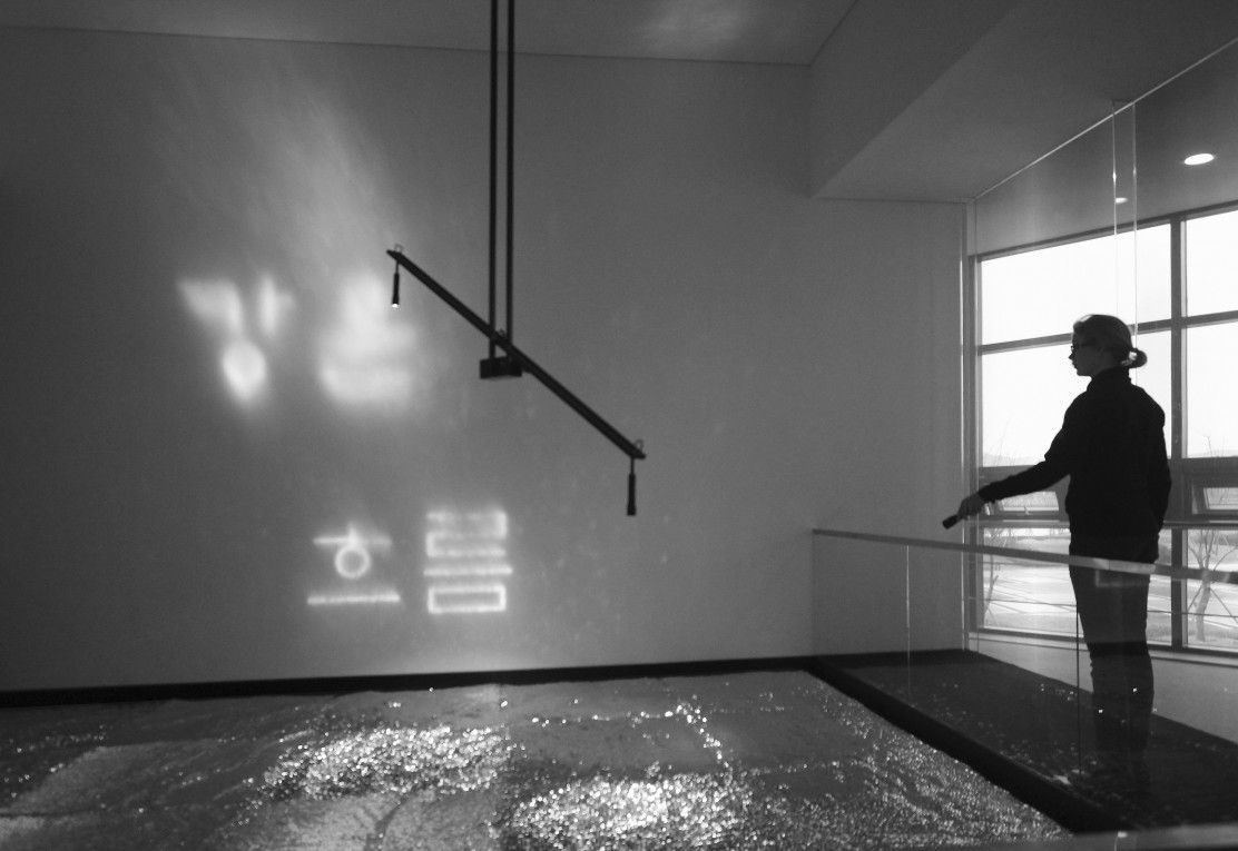 Visitor interacting with the installation using a torch