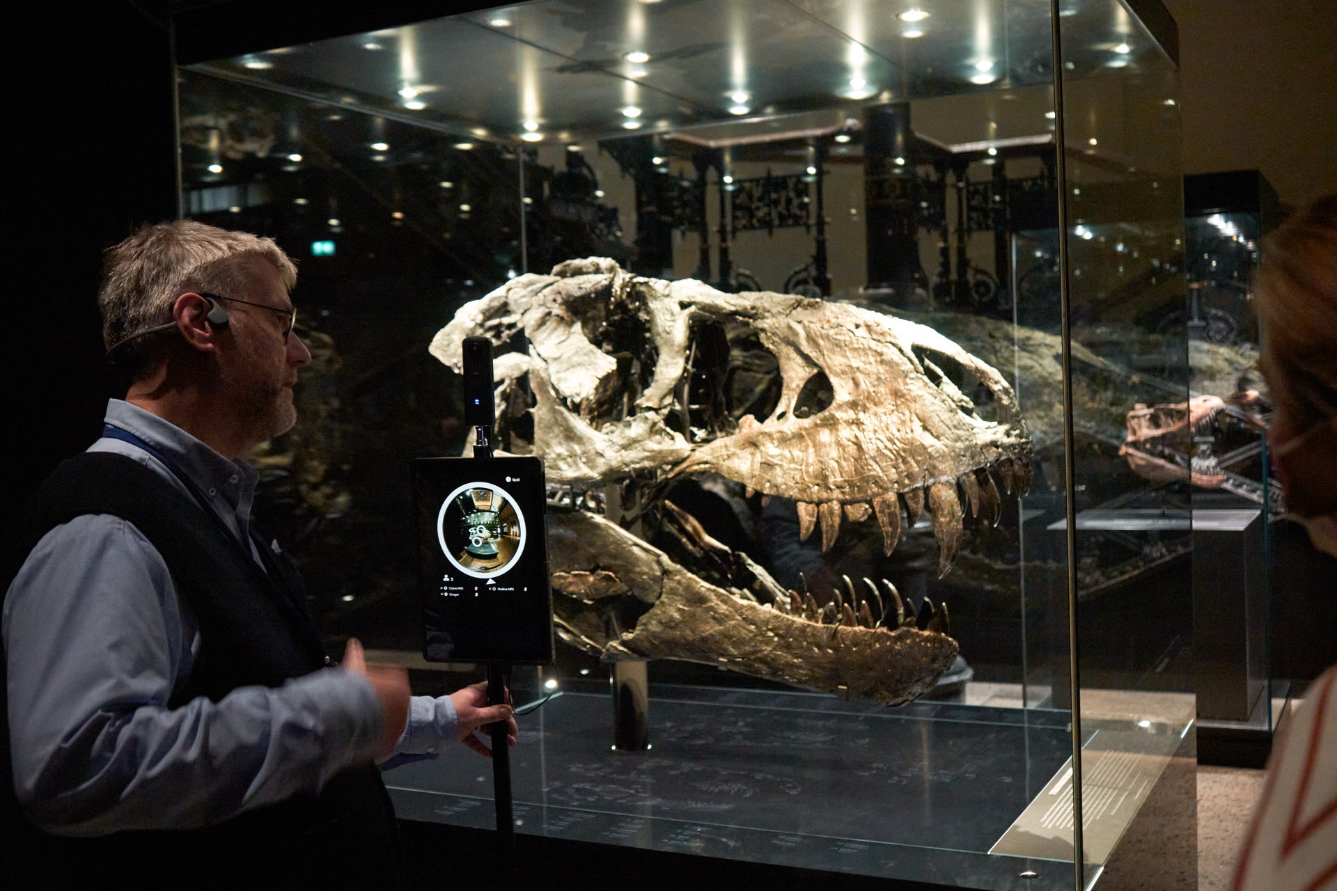 Visitor using tablet to interact with museum exhibits